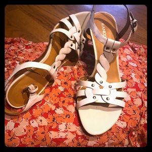 White sandal wedged heel shoes.